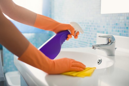Local window cleaning service handling access in a narrow Islington street